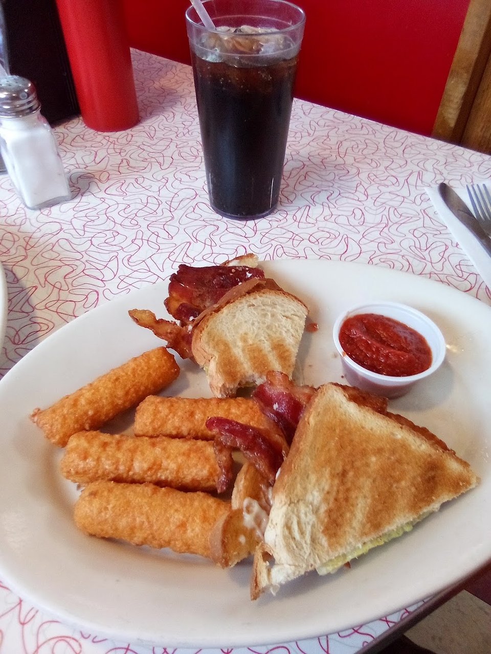 Breakfast plates beside coffee and toast.
